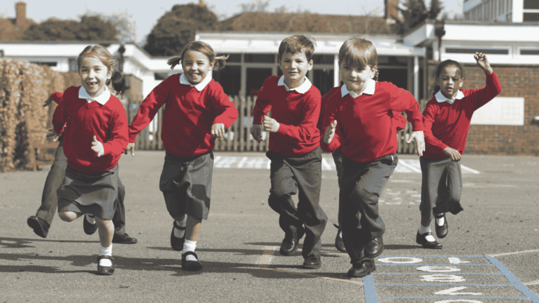 young primary school children running in the playground