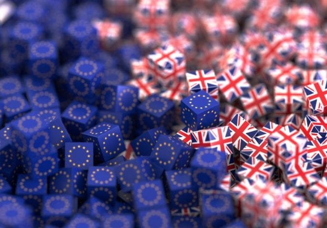 A pile of cubes covered in Union Jacks and mixed with another pile of cubes which are covered in European flags.