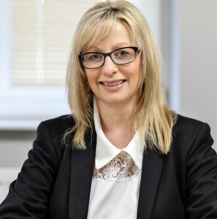 The female director of a construction company strikes a pose for a photograph in honour of International Women's Day.