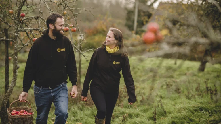 The owners of Hunts Cider are walking through their orchard chatting