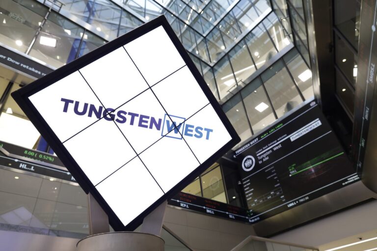 An upwards shot of the Tugsten West sign in front of towering glass fronted offices.