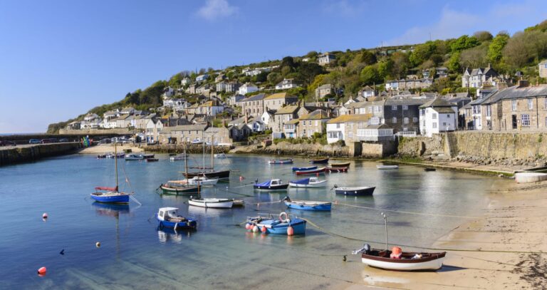 A sun drenched view of Mousehole village and harbour.