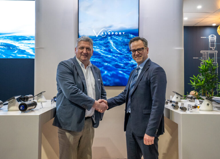 Two men shaking hands on a deal from family owned manufacturer Valeport acquired by mulitnational Teledyne Marine.