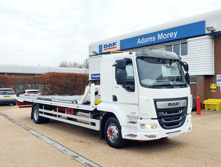 A white DAF truck is parked outside Adams Morey dealership.