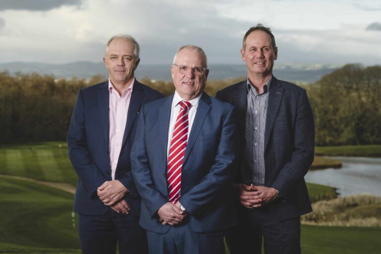 Paul Crocker, Andrew Richards and Scott Bentley strike a pose at a golf course.