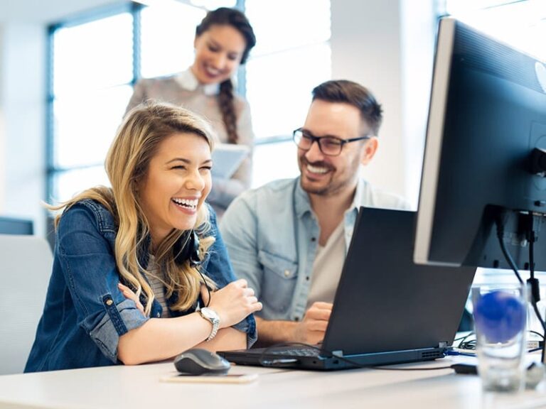 Three Tax Advisers sitting in front of computer.