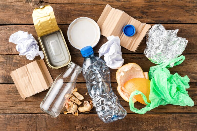 A collection of waste items gathered together on a wooden table.