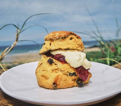 Traditional Cornish Clotted Cream Scone Served At The Beach On A Sunny Day.