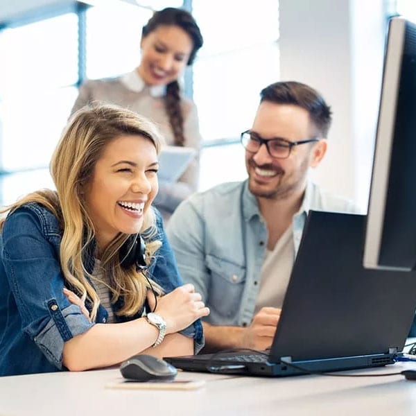 Three Tax Advisers sitting in front of computer.