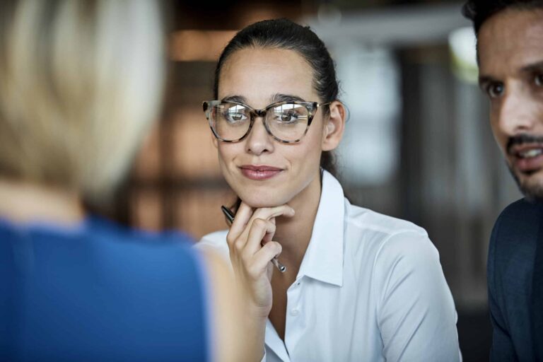 A close up of a woman in a meeting.