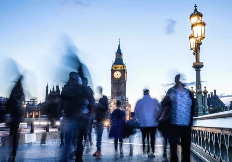 People walking along bridge towards Big Ben in London