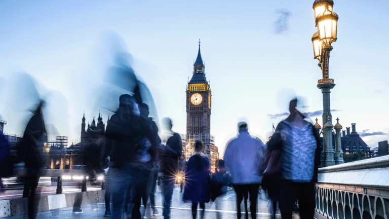 People walking along bridge towards Big Ben in London.