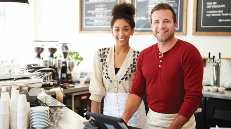 Employee team behind counter in cafe.