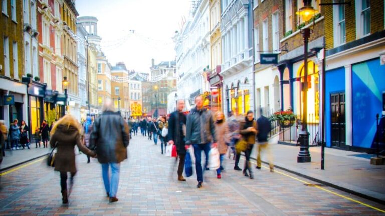 A blur of shoppers on a busy high street on a winters day.