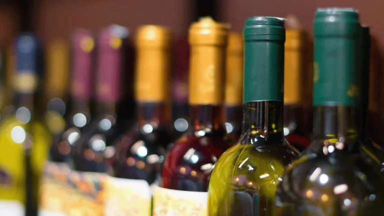 A shelf brimming with wine bottles