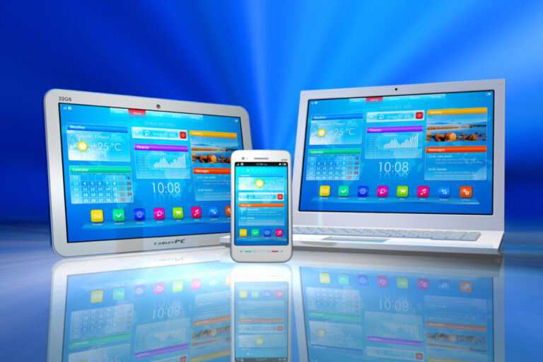 A laptop, tablet and telephone displaying icons and images on their screens.