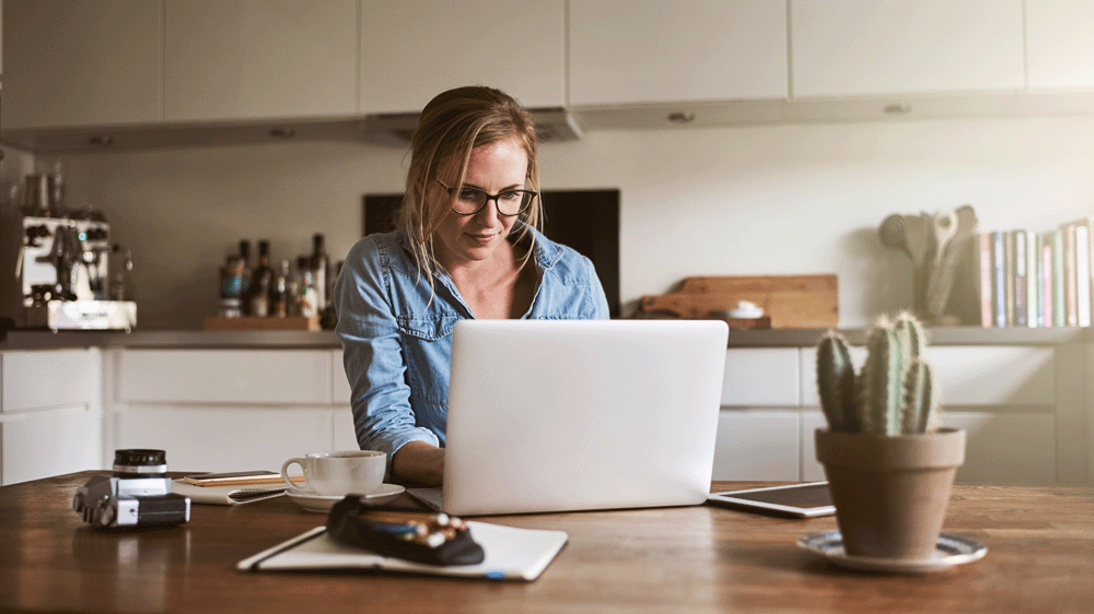 Woman home working in kitchen