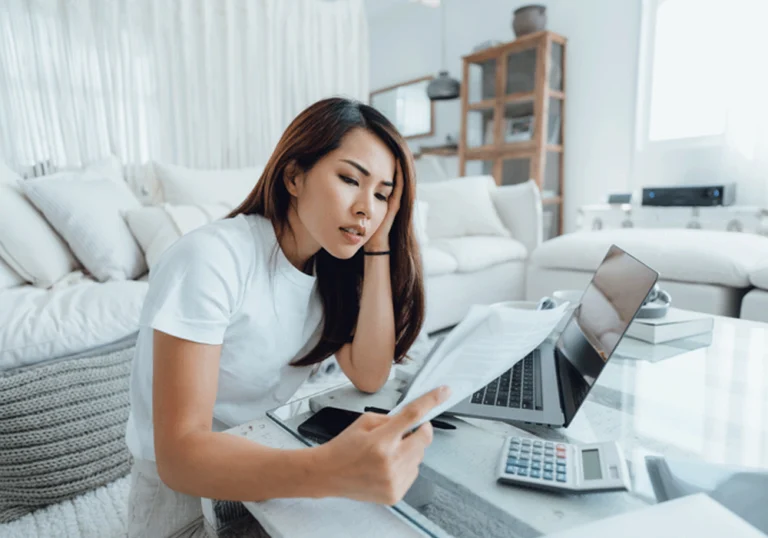 Woman pouring over paperwork