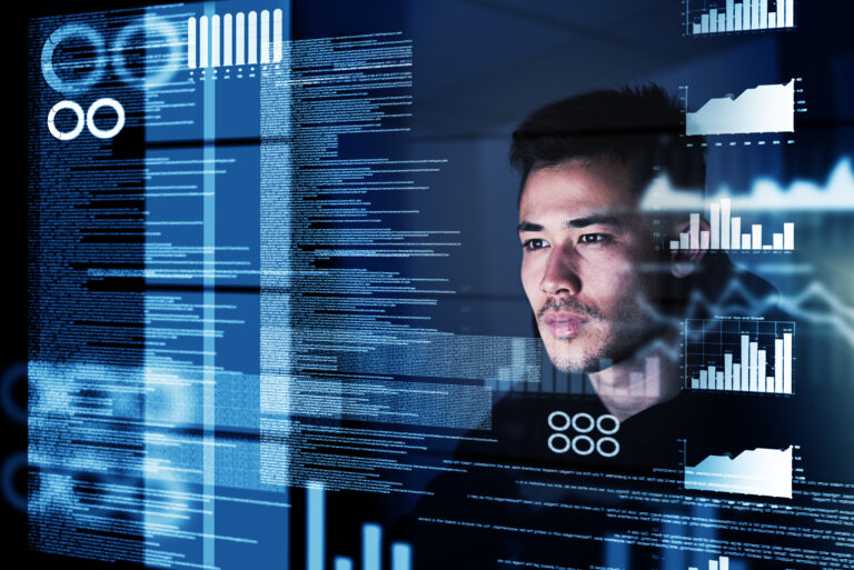 Man looking at a computer screen, analysing the data