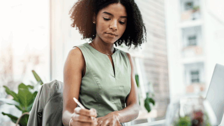 A woman works diligently in an office