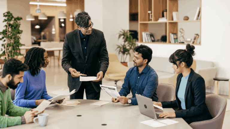 A team of five in a casual business meeting discussing a serious topic