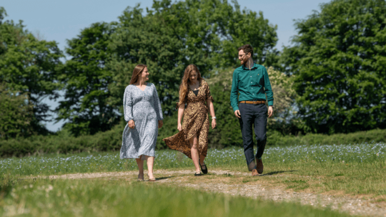 Three PKF Francis Clark colleagues walk through a field in Wiltshire.