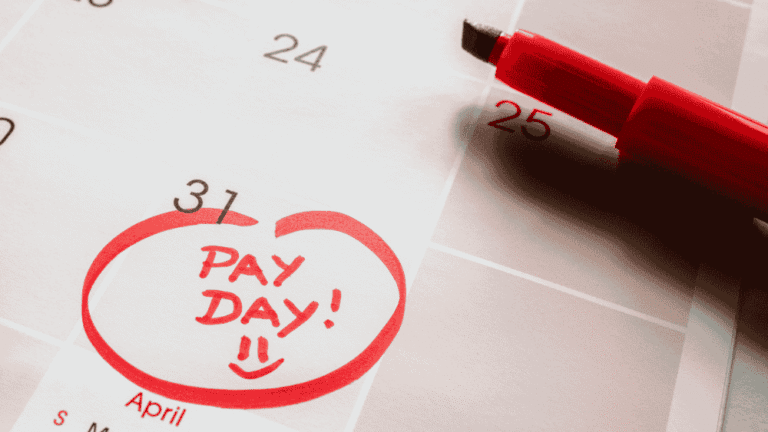 A calendar with the last date of the month circled - it has 'pay day' written on it with a smiley face.
