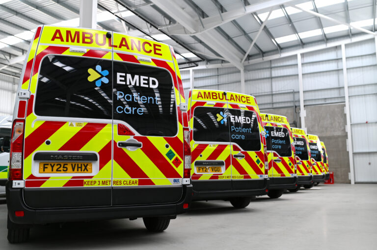 A row of ambulances inside a depot