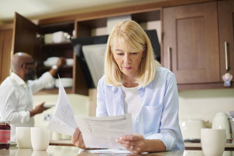 Women sat at table looking at paperwork